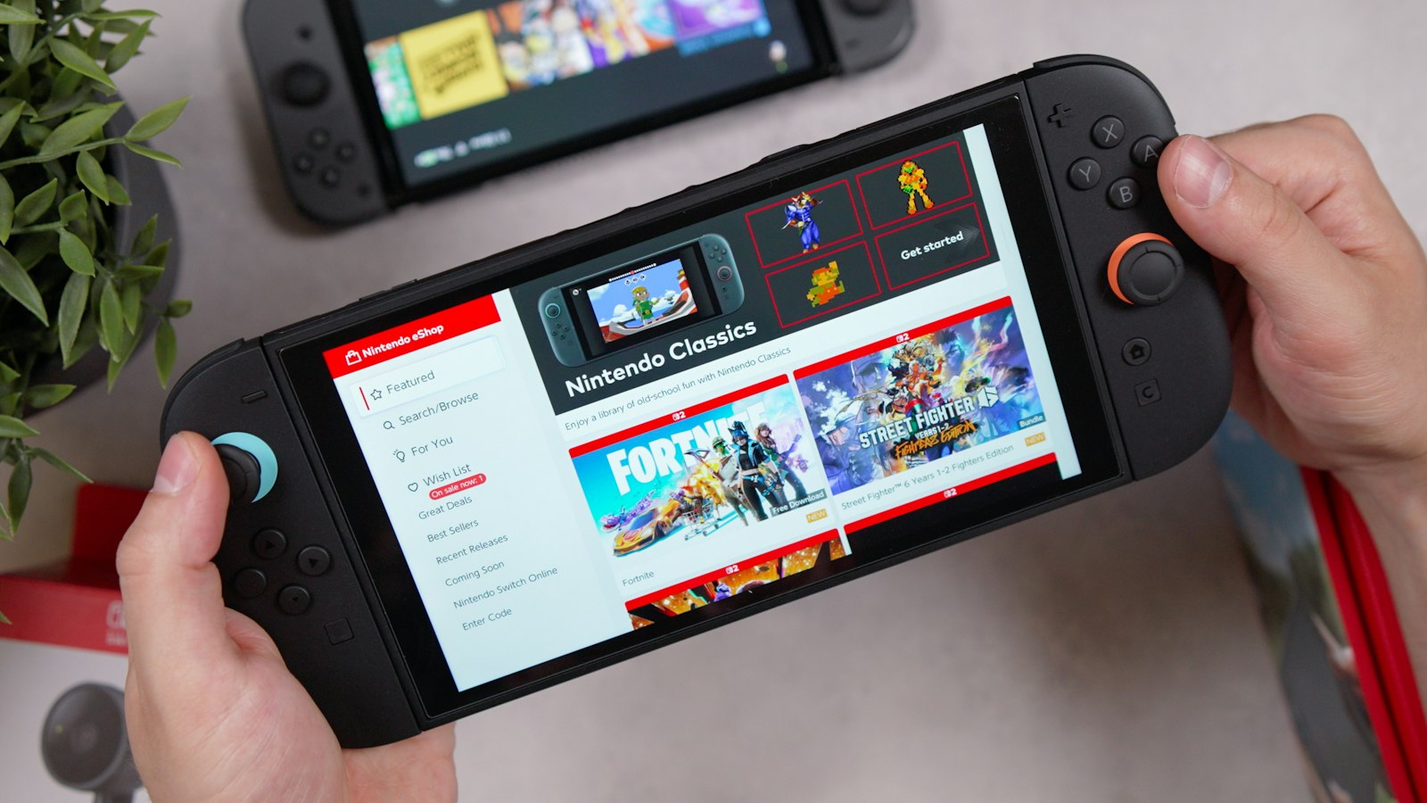 Hands holding a landscape handheld game console