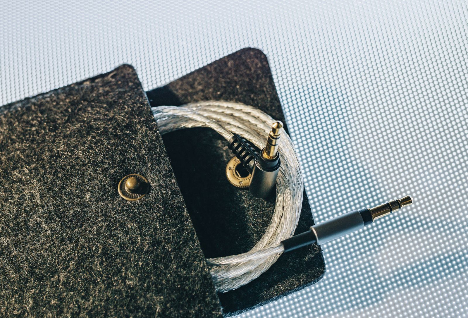 Coiled cable stored in a soft gray pouch